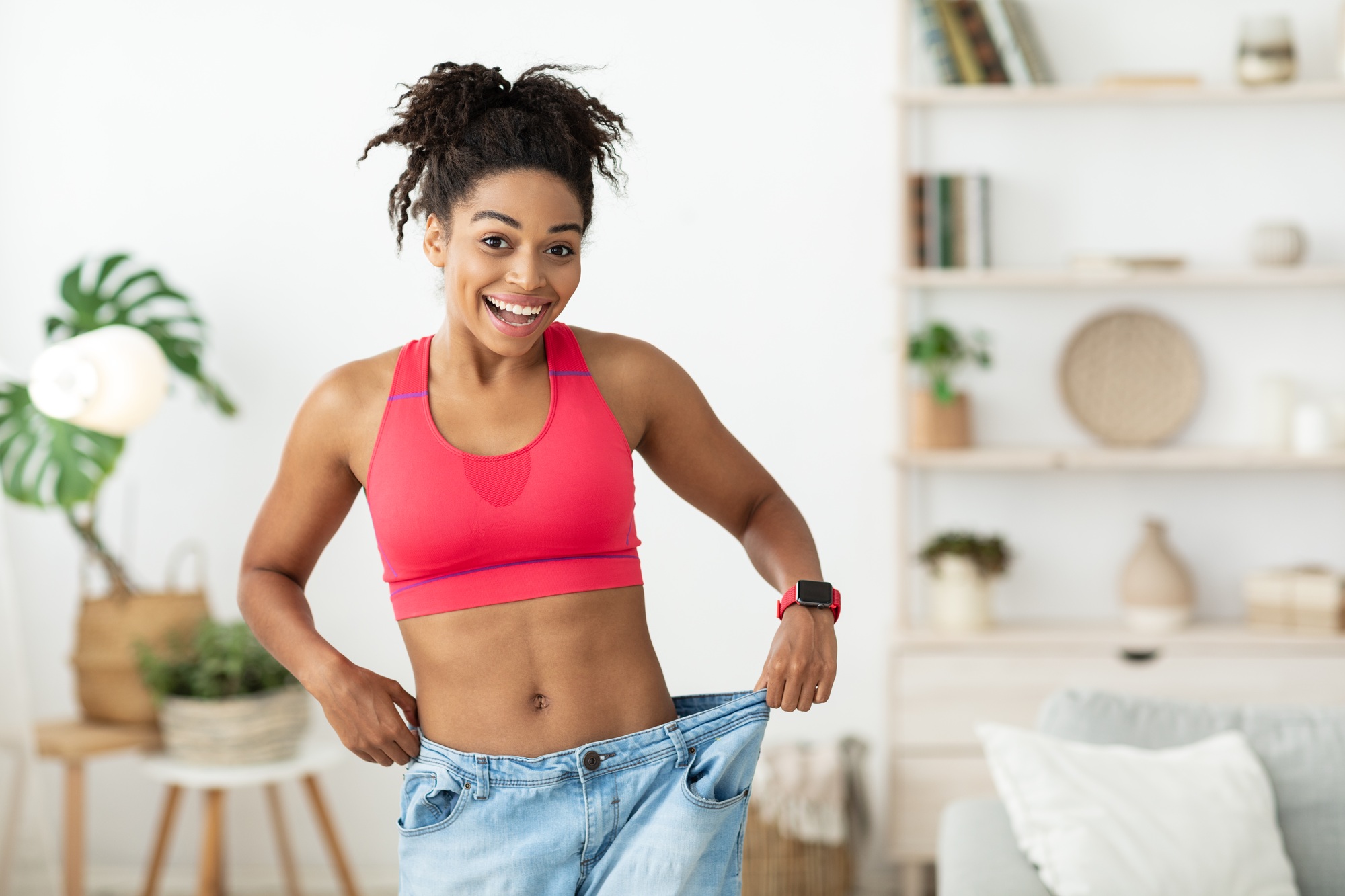 Excited Girl Wearing Too Big Jeans After Weight Loss Indoor